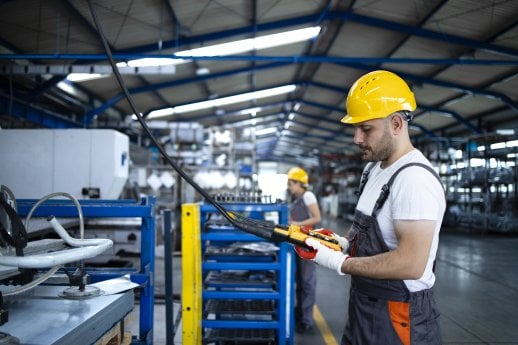 factory-worker-wearing-uniform-hardhat-operating-industrial-machine-with-push-button-joystick-pr.jpg